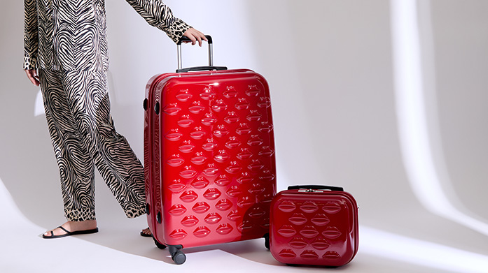Lulu Guinness Luggage Make a glamorous getaway with designer luggage from Lulu Guinness. Your ideal travel companion for the style-conscious woman. Find suitcases and vanity cases, each embossed with the iconic alluring lips pattern and a high gloss finish.